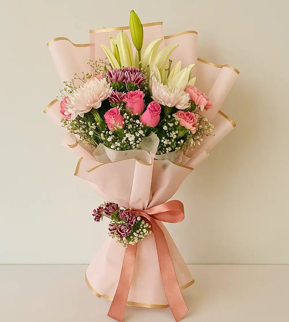 Lilies, Carnation & Disbud in Blush Wrap